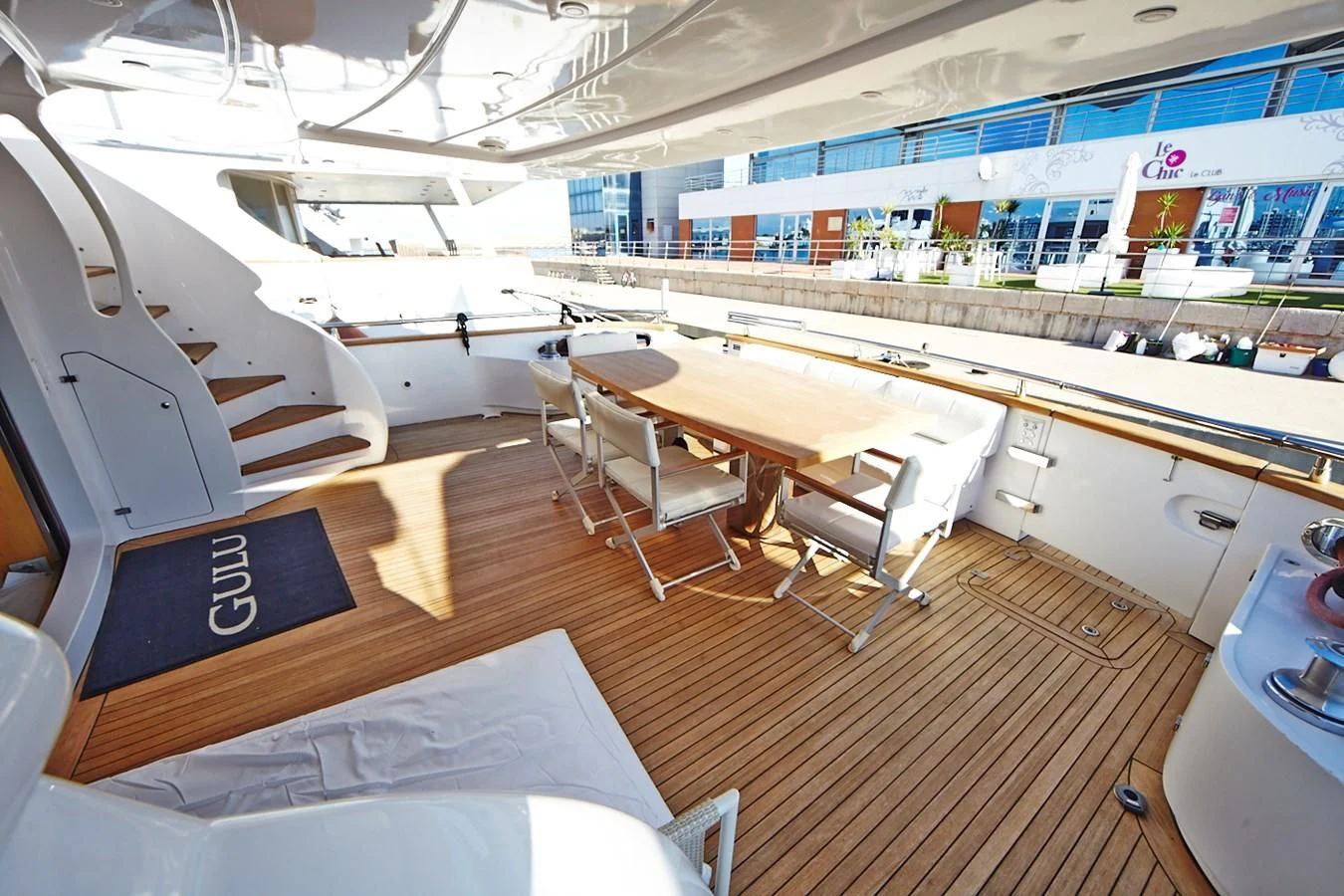 a room with tables and chairs aboard GULU Yacht for Sale