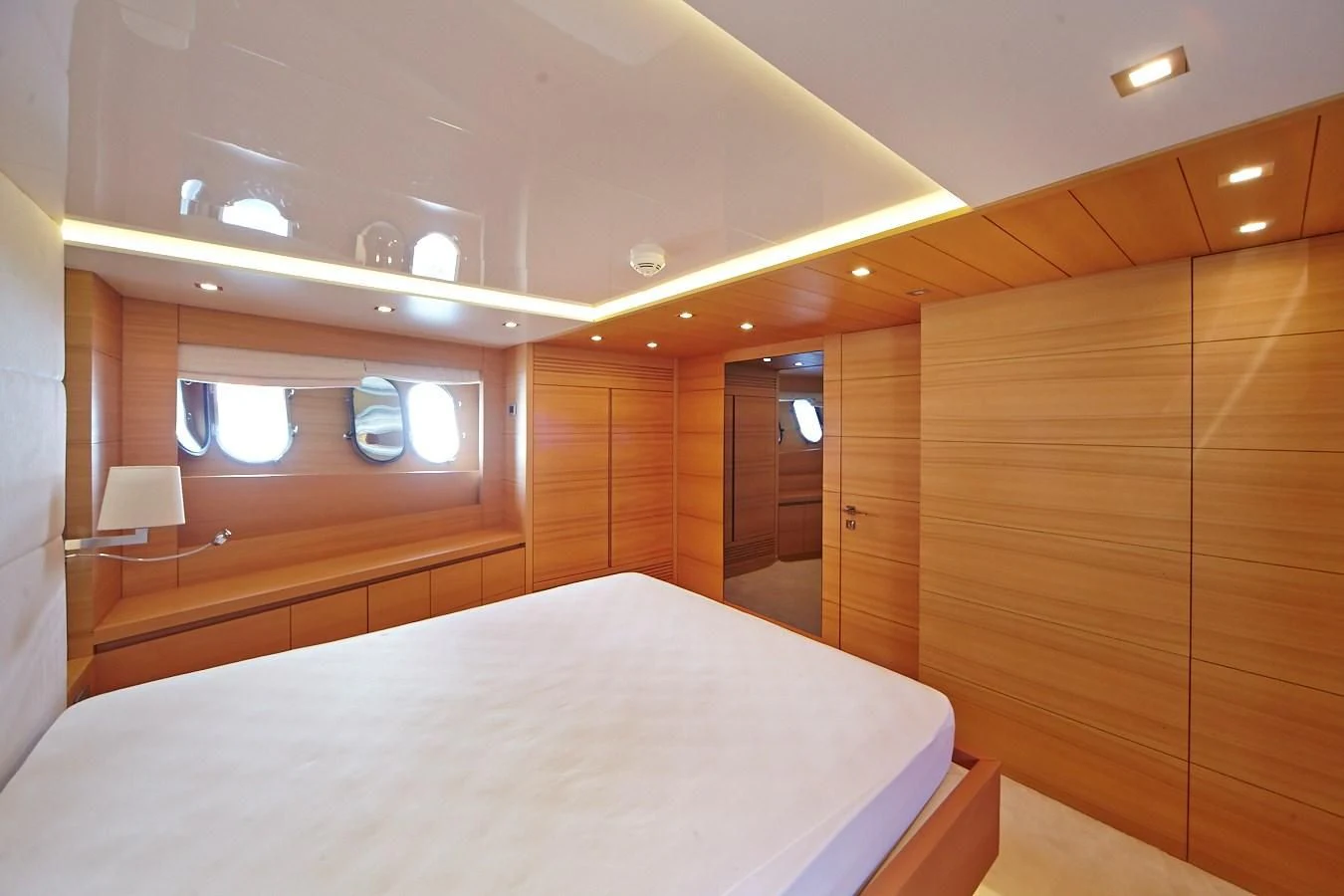 a room with a bed and a mirror aboard GULU Yacht for Sale