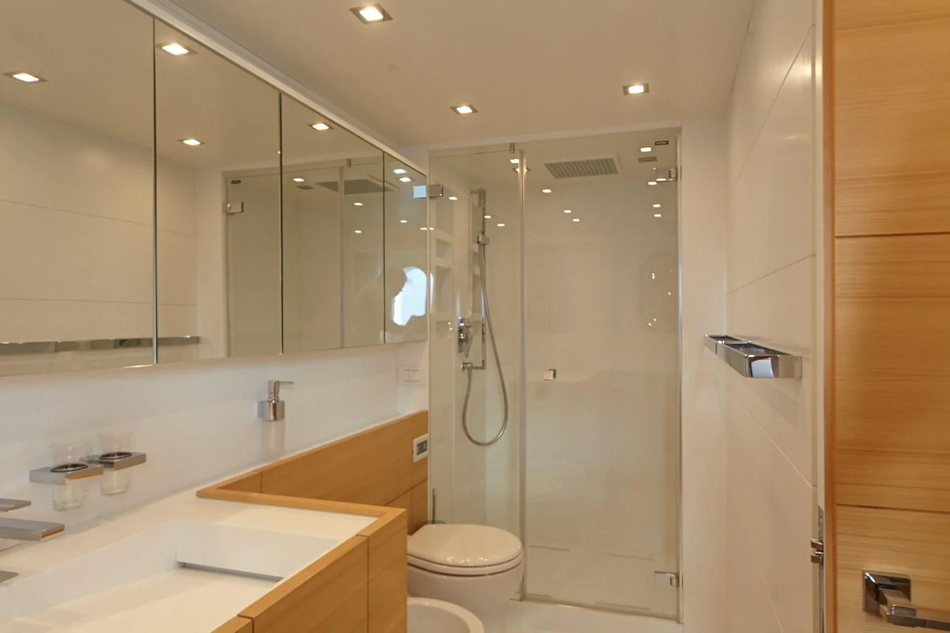 a bathroom with a glass shower aboard GULU Yacht for Sale