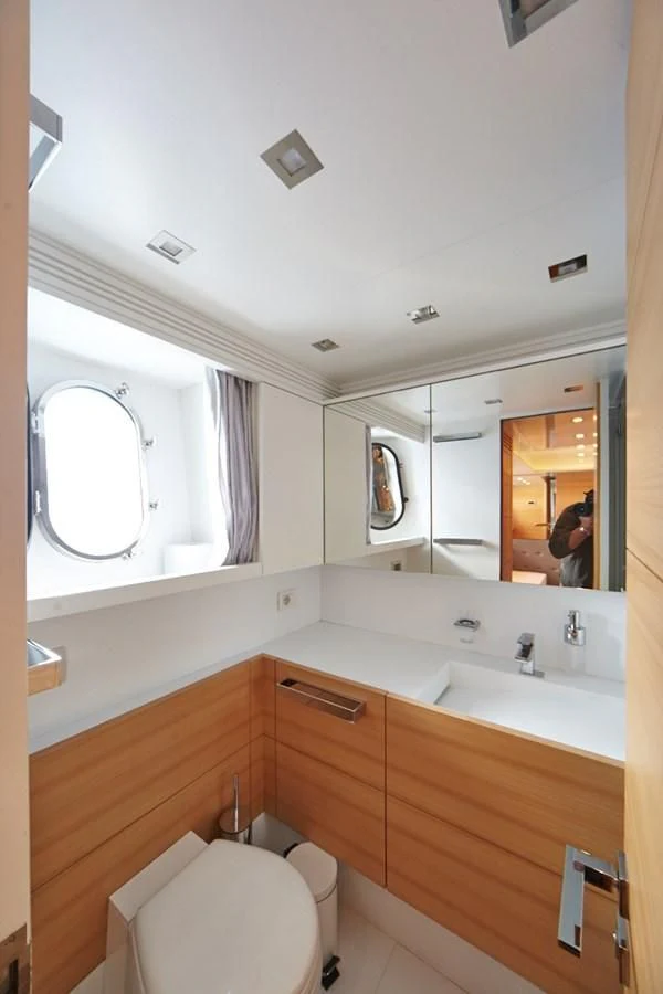 a bathroom with a toilet and a sink aboard GULU Yacht for Sale