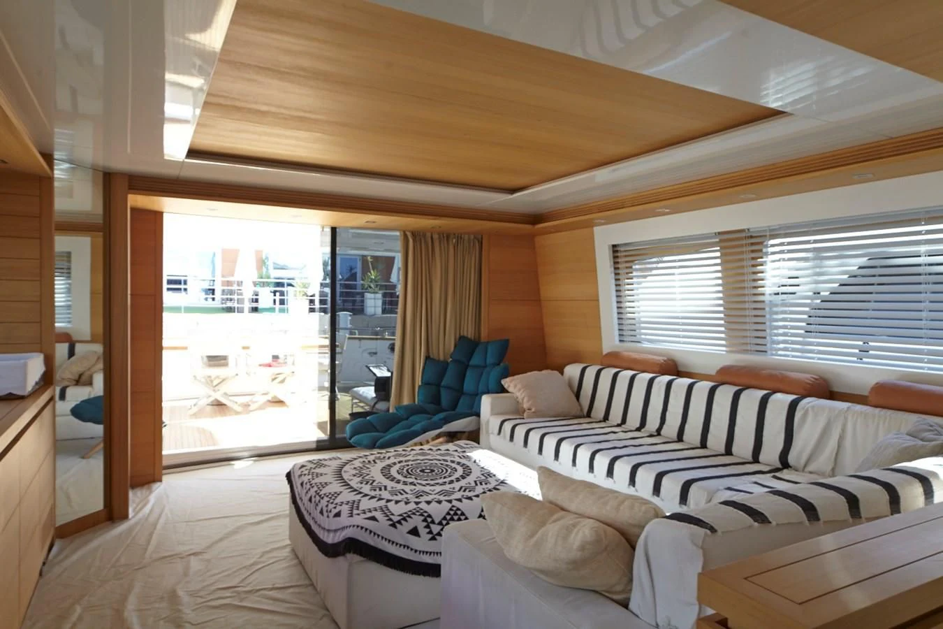 a room with a bed and a chair aboard GULU Yacht for Sale
