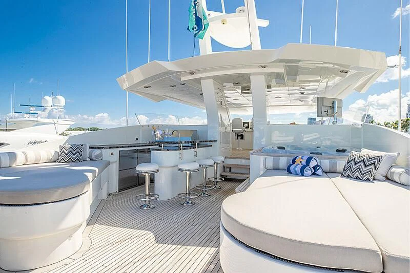 a large white boat with a white bed and white pillows aboard ARIES Yacht for Sale