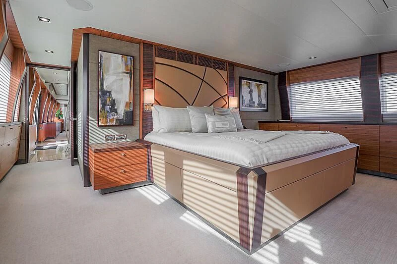 a bedroom with a bed and a mirror aboard ARIES Yacht for Sale