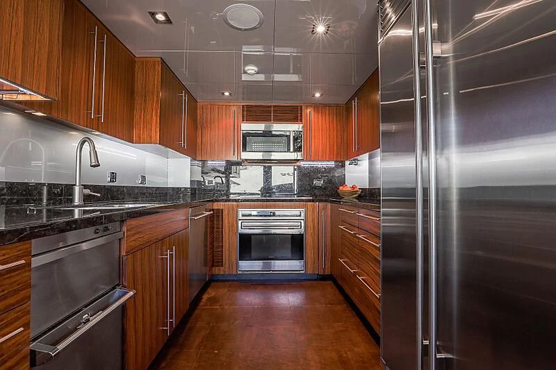 a kitchen with stainless steel appliances aboard ARIES Yacht for Sale