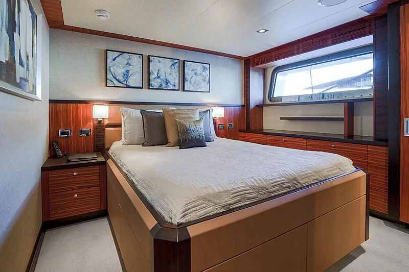 a bed with a large window aboard ARIES Yacht for Sale