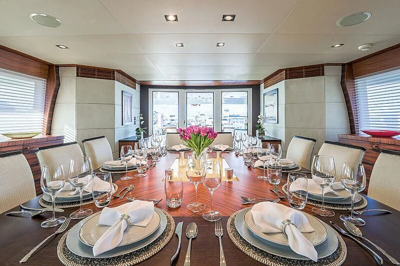 a table with plates and glasses aboard ARIES Yacht for Sale