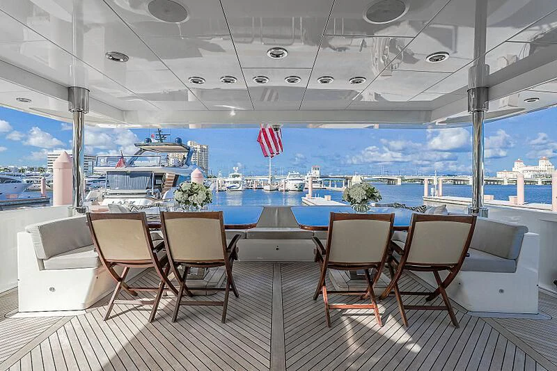 a deck with chairs and a flag aboard ARIES Yacht for Sale