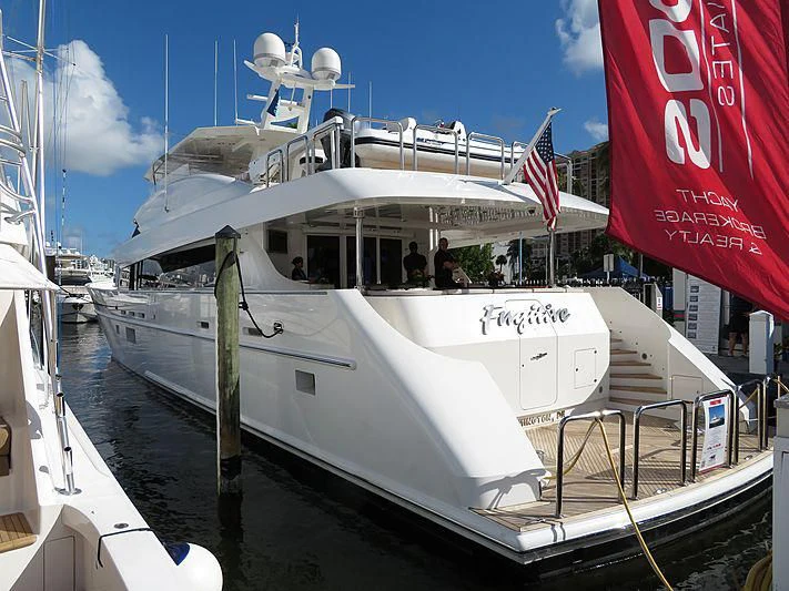 a boat with a flag on the front aboard ARIES Yacht for Sale