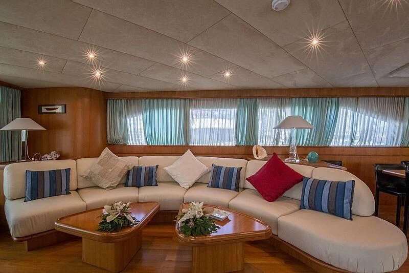 a living room with a couch and a table aboard PIERPAOLO IV Yacht for Sale