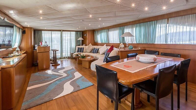 a living room with a table and chairs aboard PIERPAOLO IV Yacht for Sale