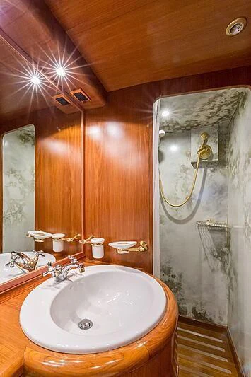 a bathroom with a sink and a mirror aboard PIERPAOLO IV Yacht for Sale