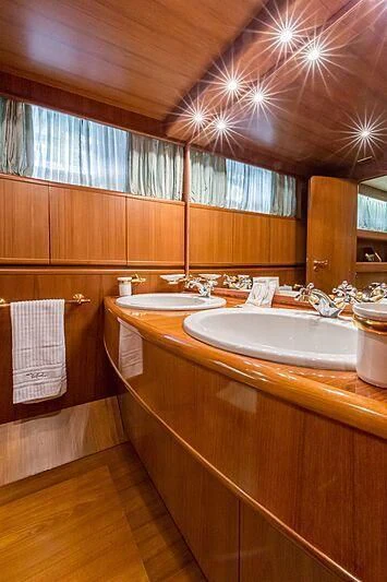 a bathroom with wooden cabinets aboard PIERPAOLO IV Yacht for Sale