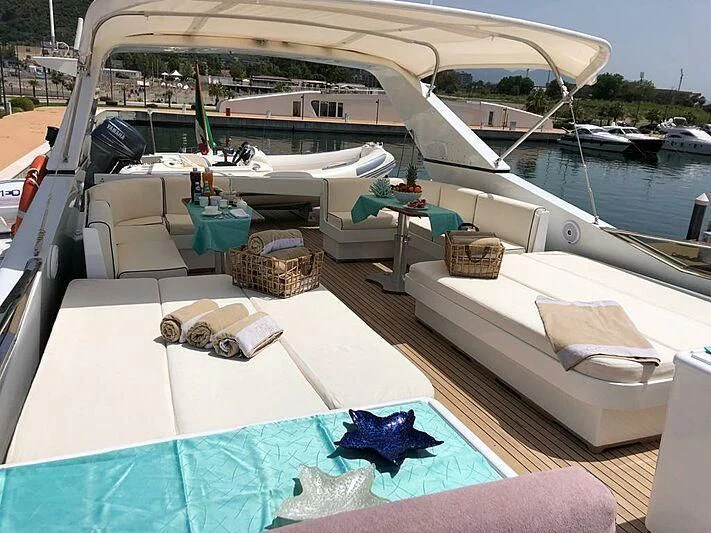 a boat with a table and chairs on the deck aboard PIERPAOLO IV Yacht for Sale