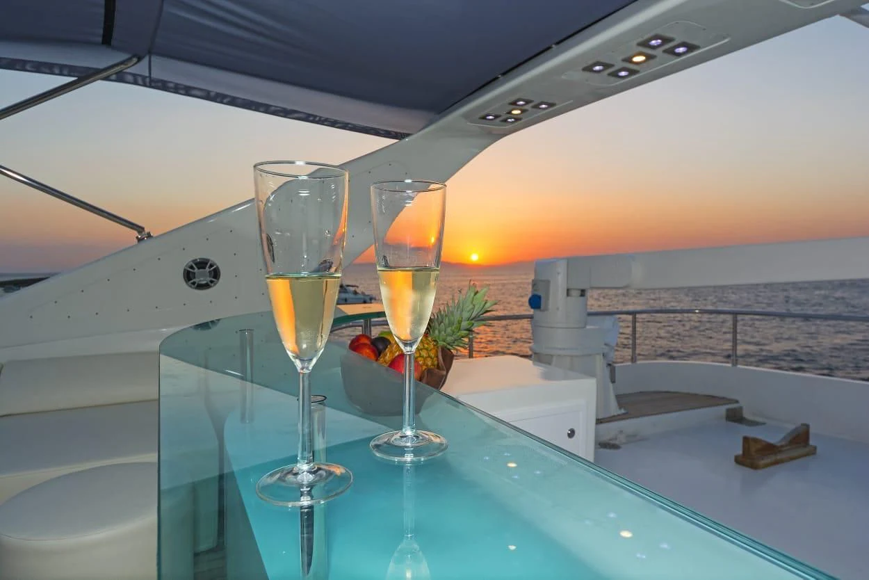 a couple of wine glasses on a table aboard MARACANA Yacht for Sale