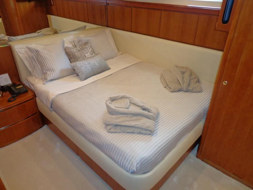 a bed with a towel on it aboard MARACANA Yacht for Sale