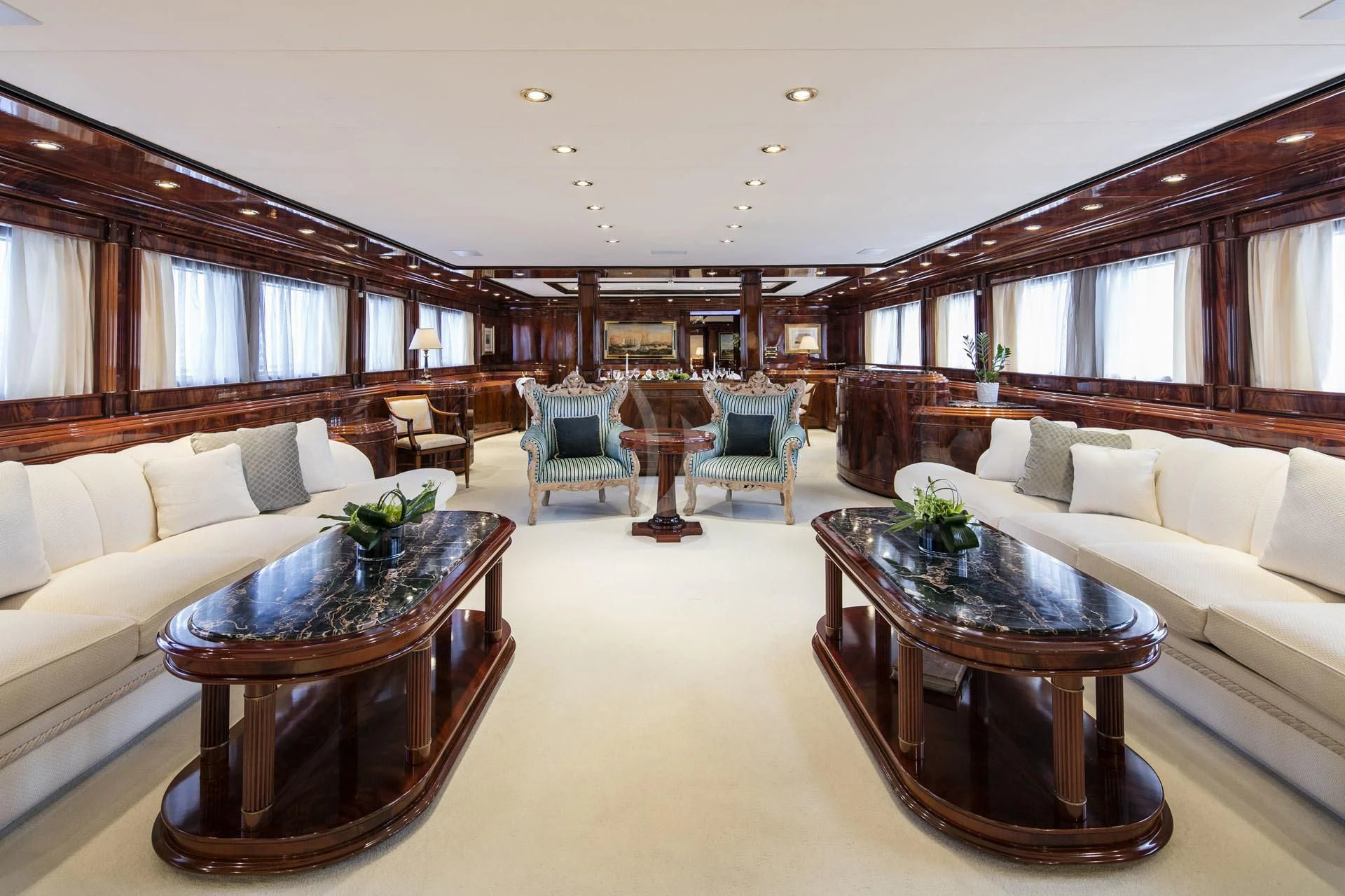 a living room with a table and couches aboard JAAN Yacht for Sale