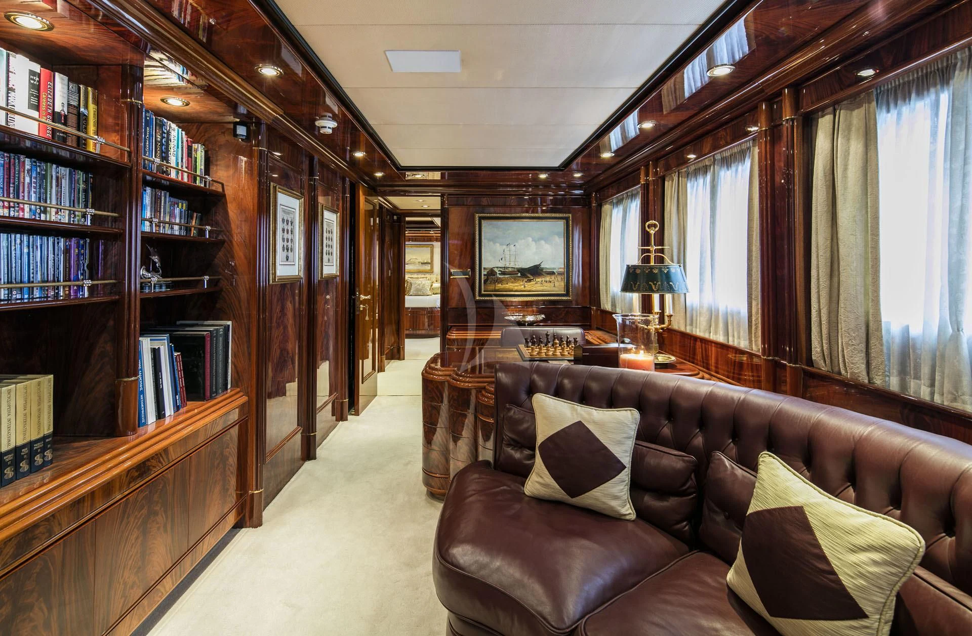 a living room with a couch and a book shelf aboard JAAN Yacht for Sale