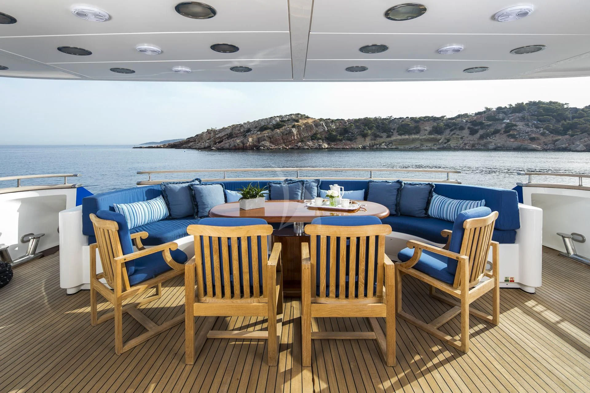 a table and chairs on a deck aboard JAAN Yacht for Sale