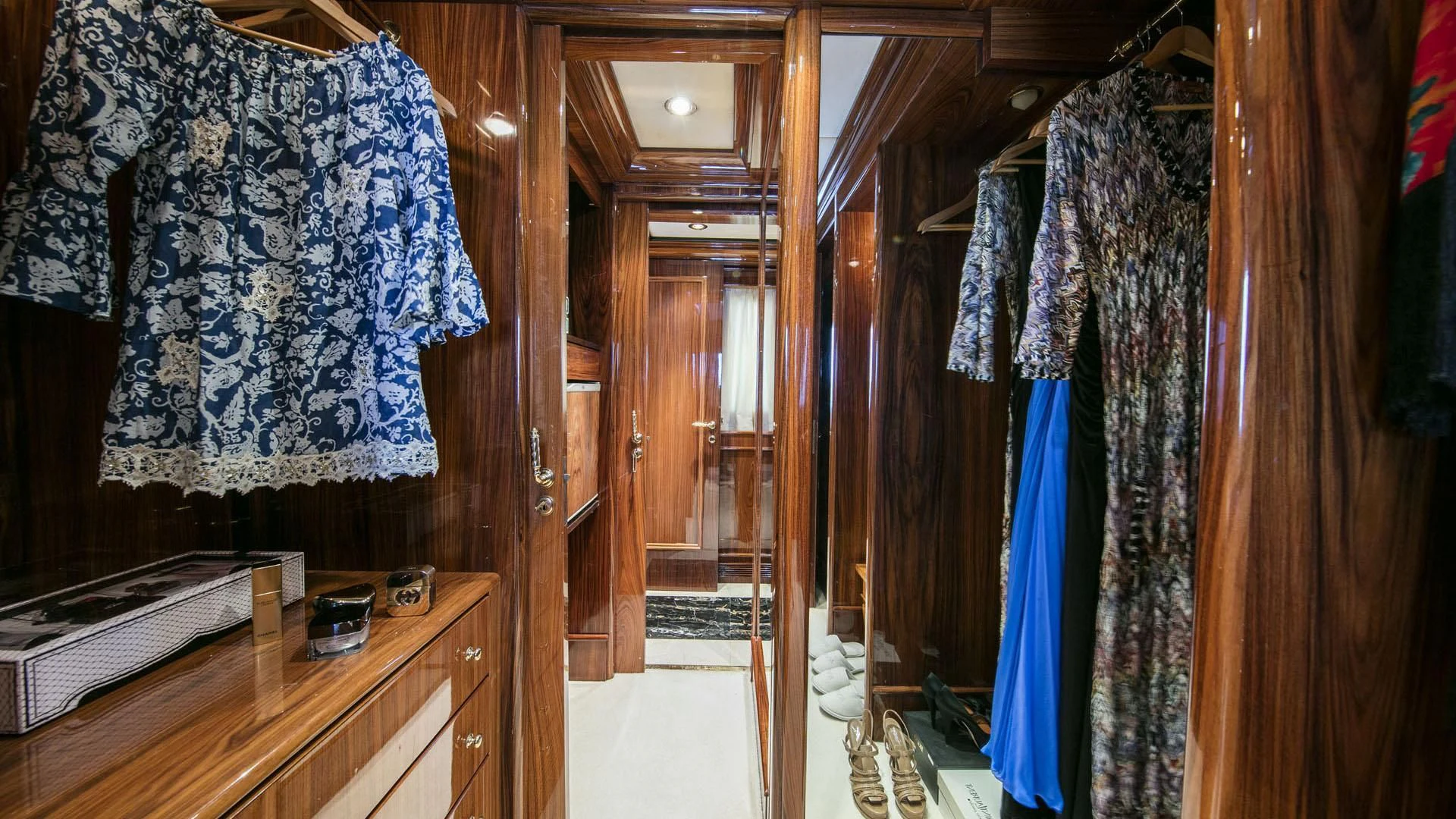 a room with a closet and clothes on the wall aboard JAAN Yacht for Sale