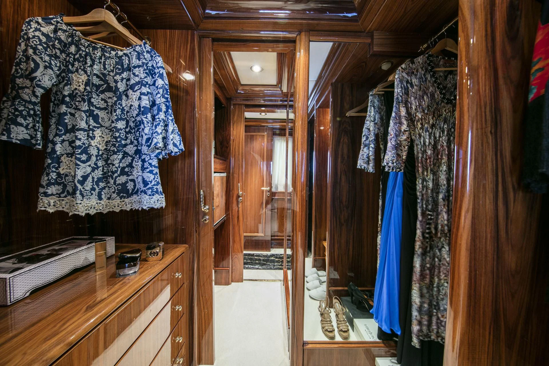 a closet with clothes on the wall aboard JAAN Yacht for Sale