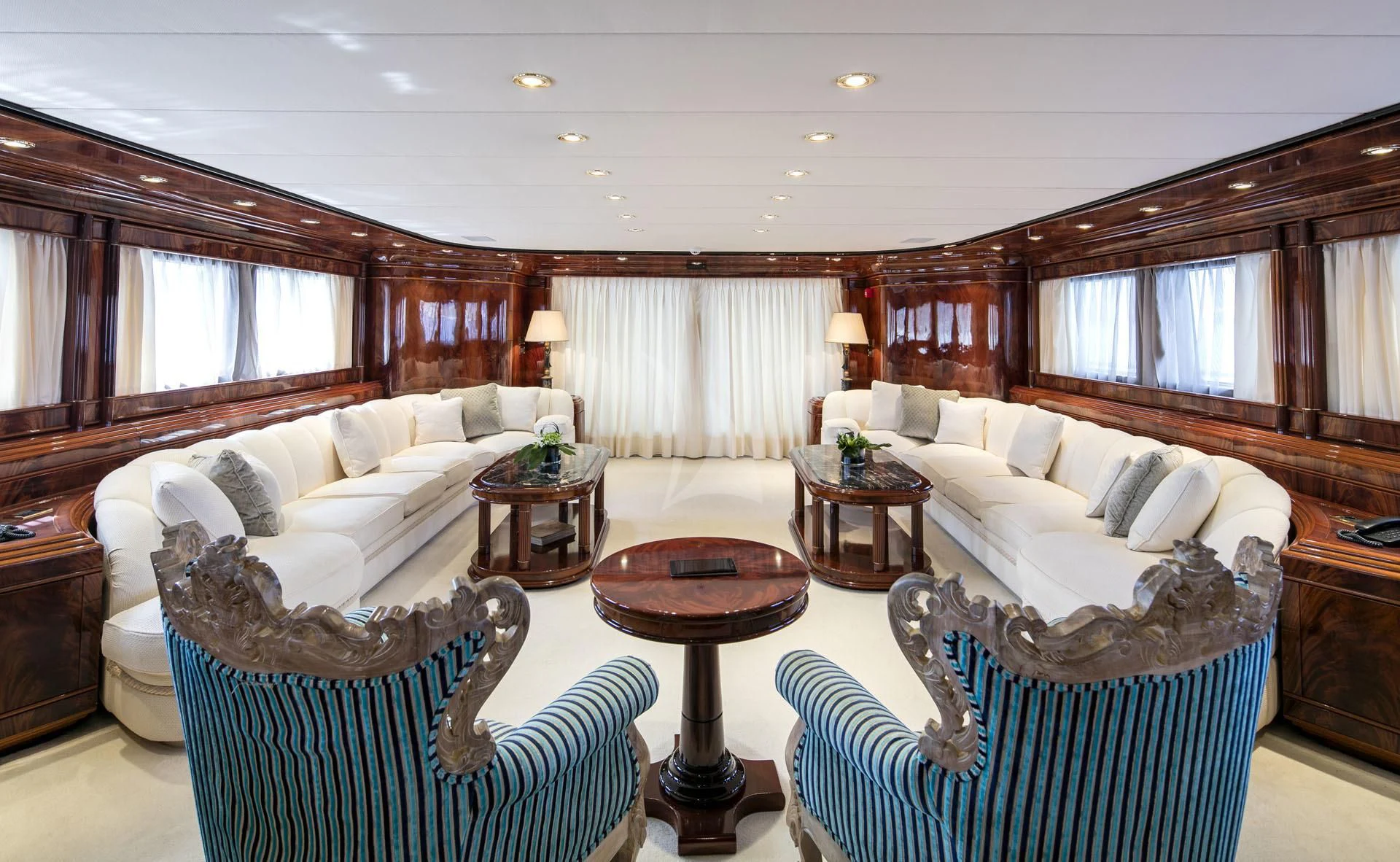 a large living room with a large bed and a table aboard JAAN Yacht for Sale