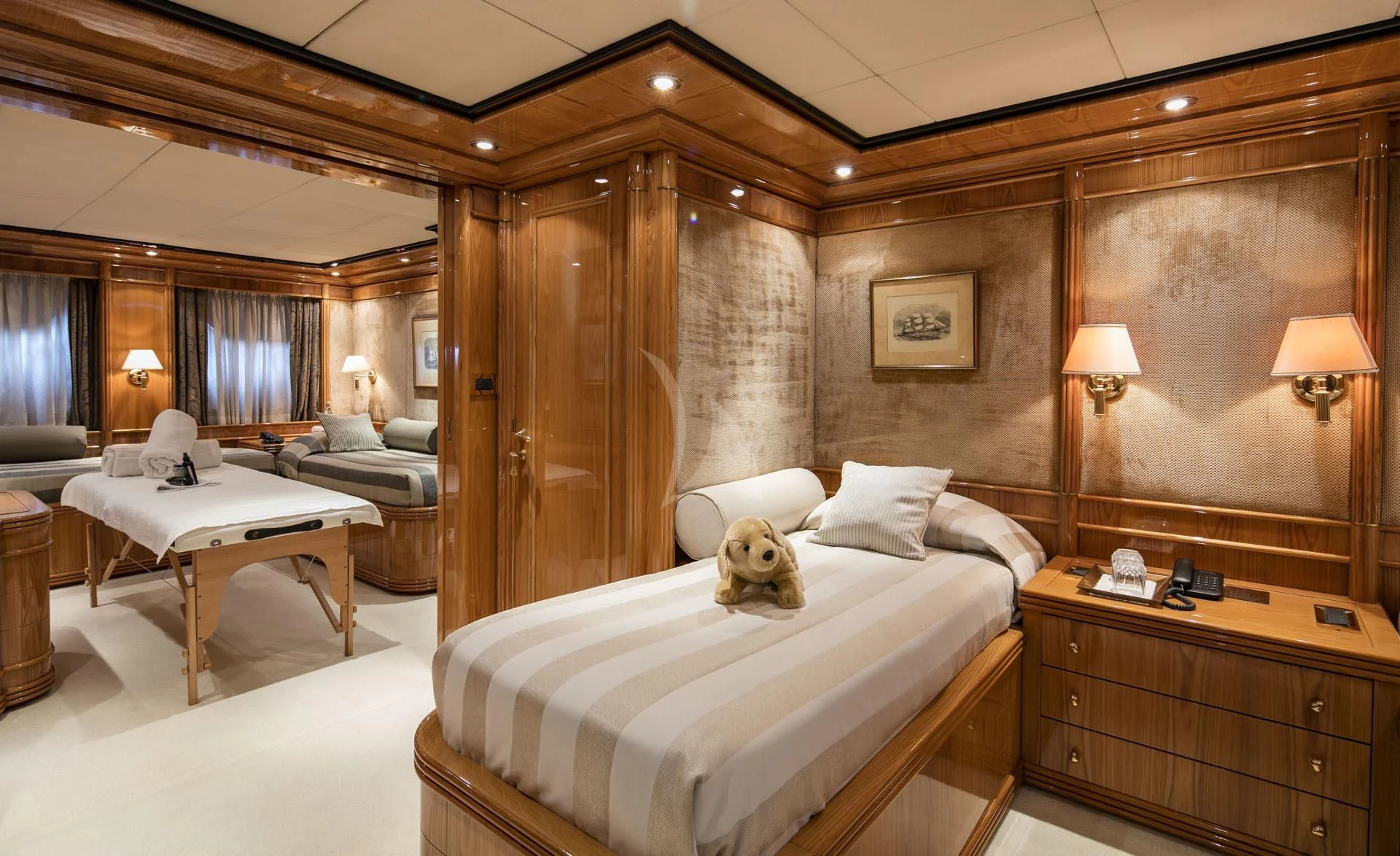 a room with a bed and a table aboard JAAN Yacht for Sale