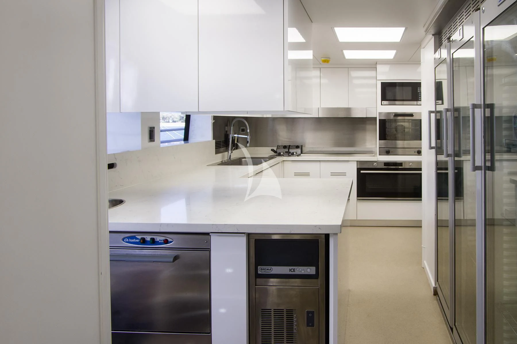 a kitchen with white cabinets aboard JAAN Yacht for Sale