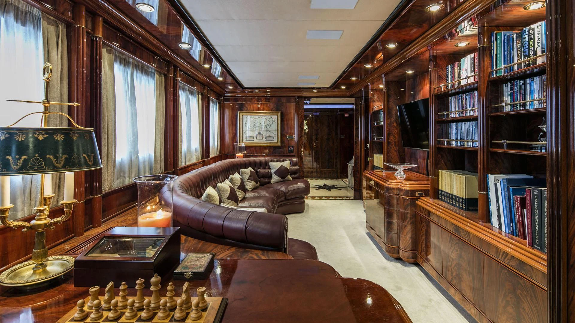 a living room with a book shelf and a couch aboard JAAN Yacht for Sale