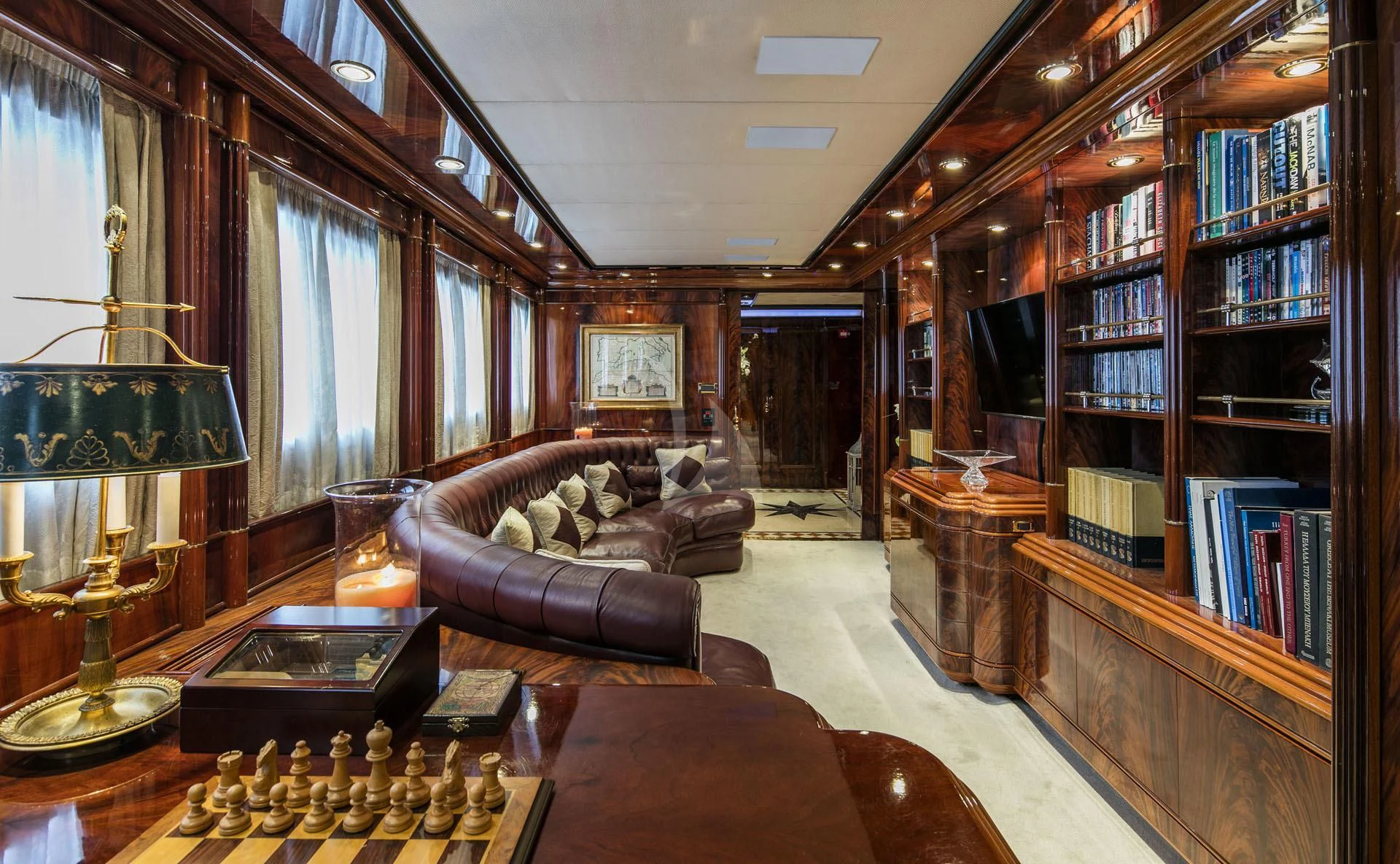 a living room with a book shelf and a lamp aboard JAAN Yacht for Sale