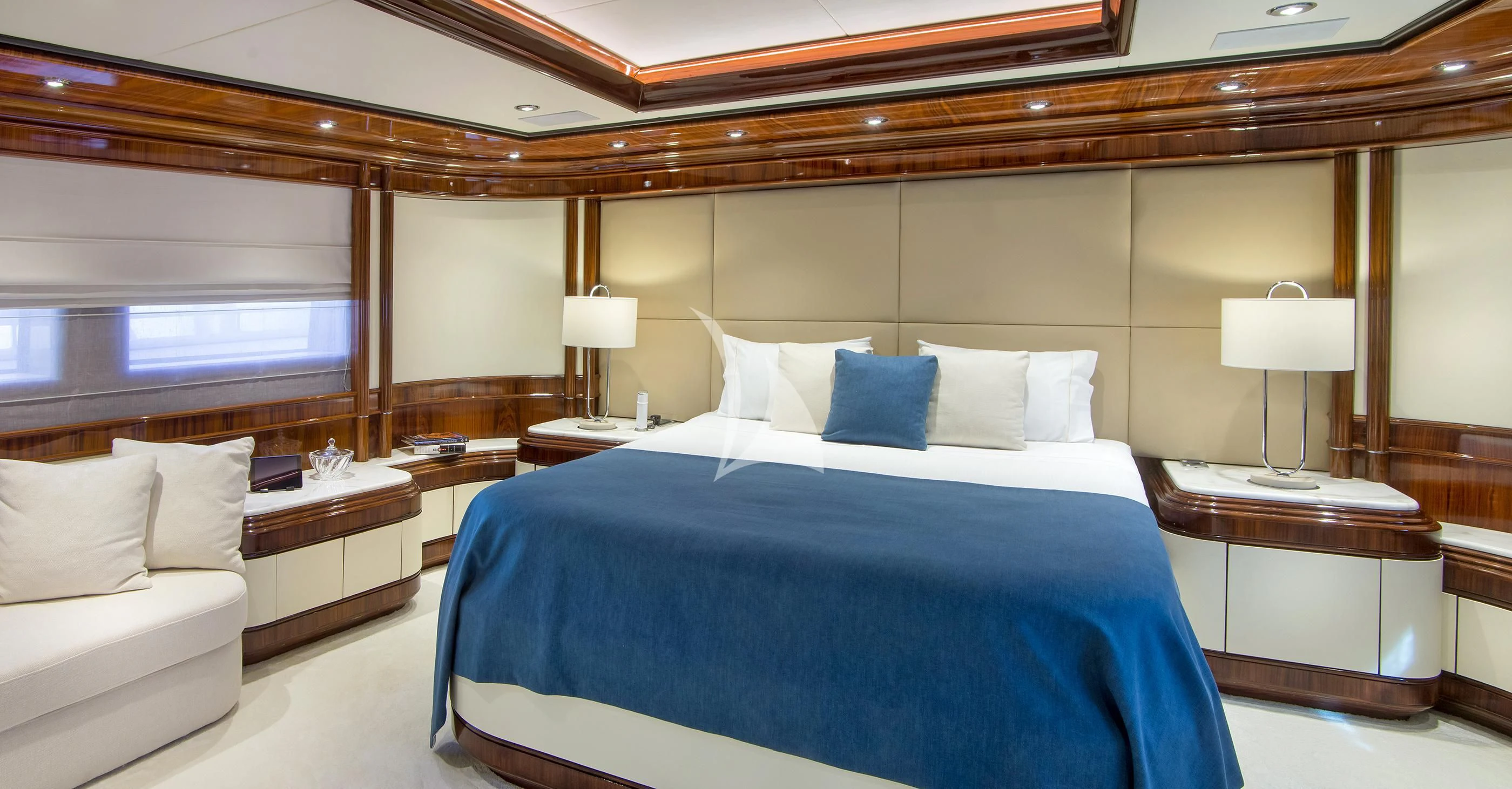 a bed with a blue and white bed spread aboard JAAN Yacht for Sale