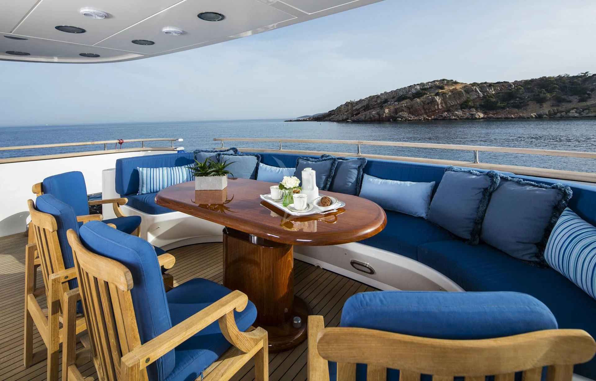 a table with chairs and a couch on a boat in the water aboard JAAN Yacht for Sale