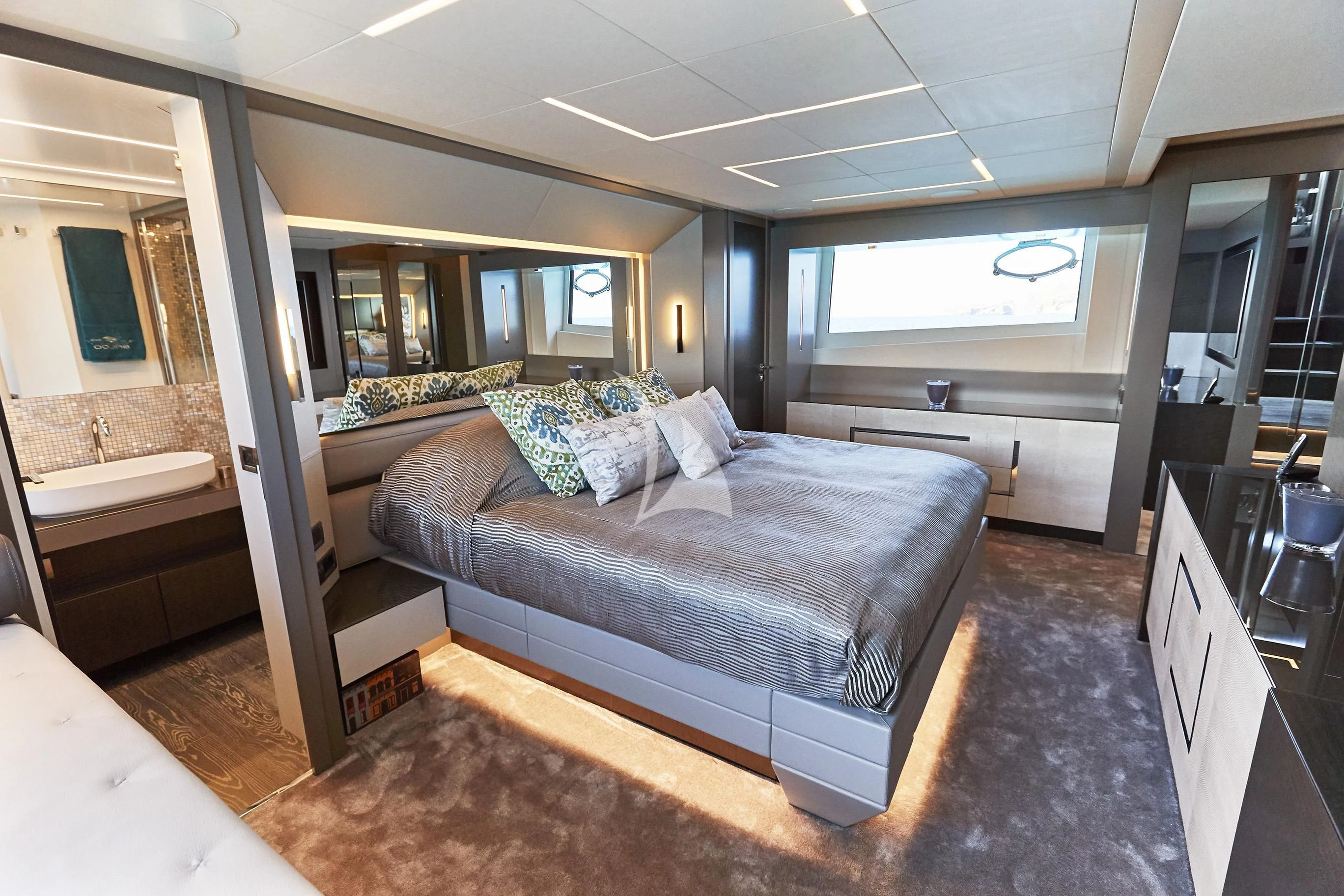 a large bedroom with a large bed aboard BALOO III Yacht for Sale