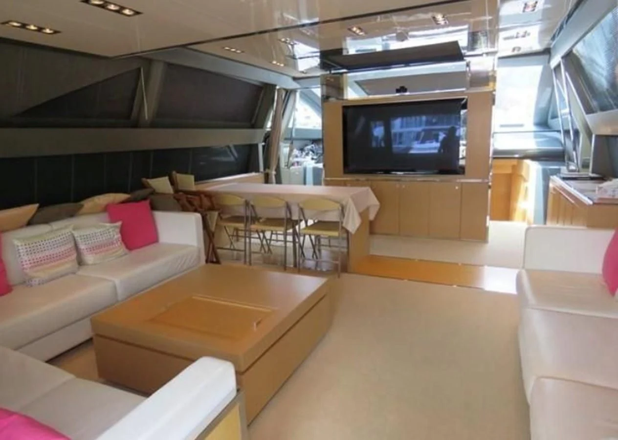 a room with couches and a tv aboard RIVA 86 DOMINO Yacht for Sale