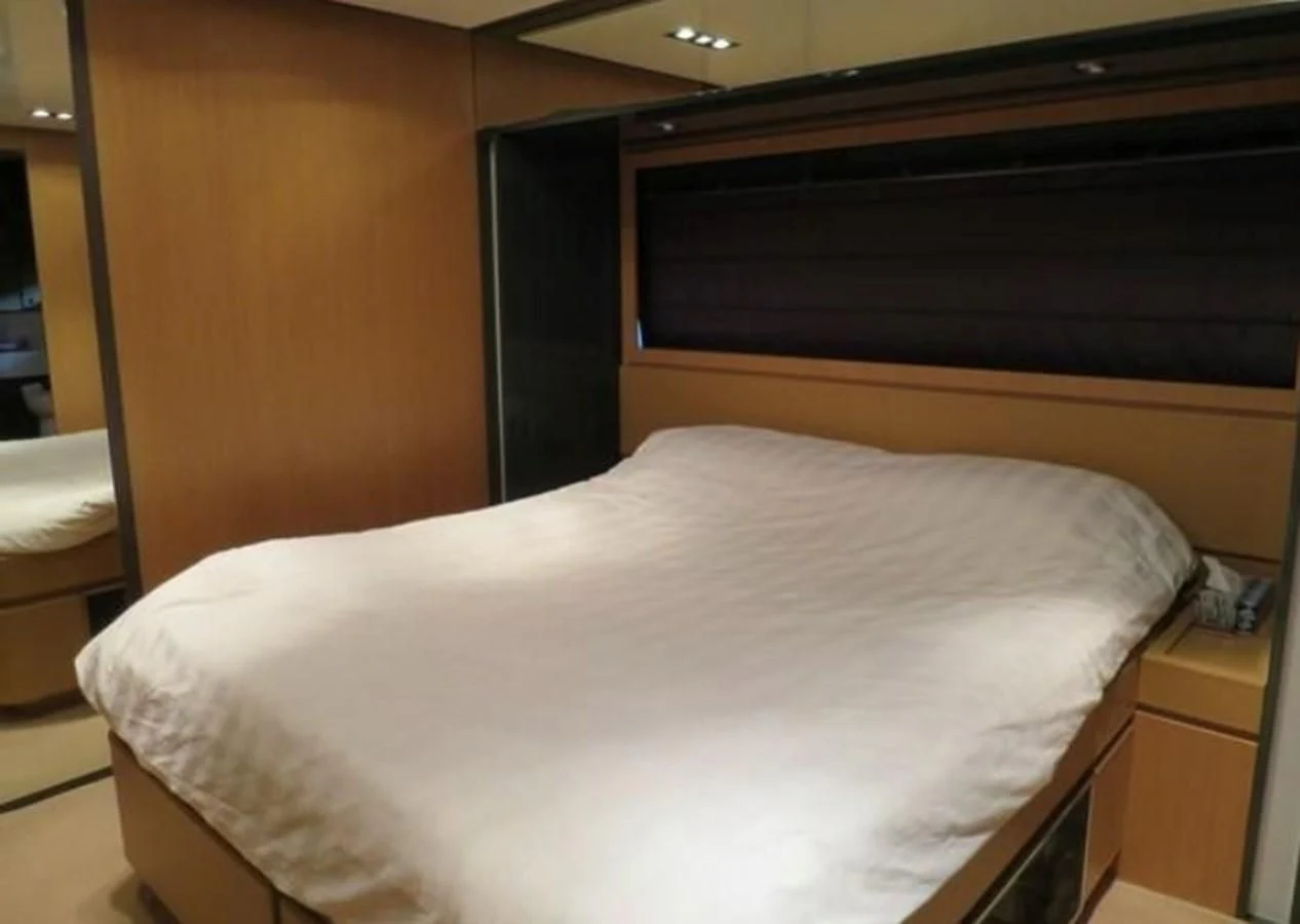a bed with a white sheet aboard RIVA 86 DOMINO Yacht for Sale
