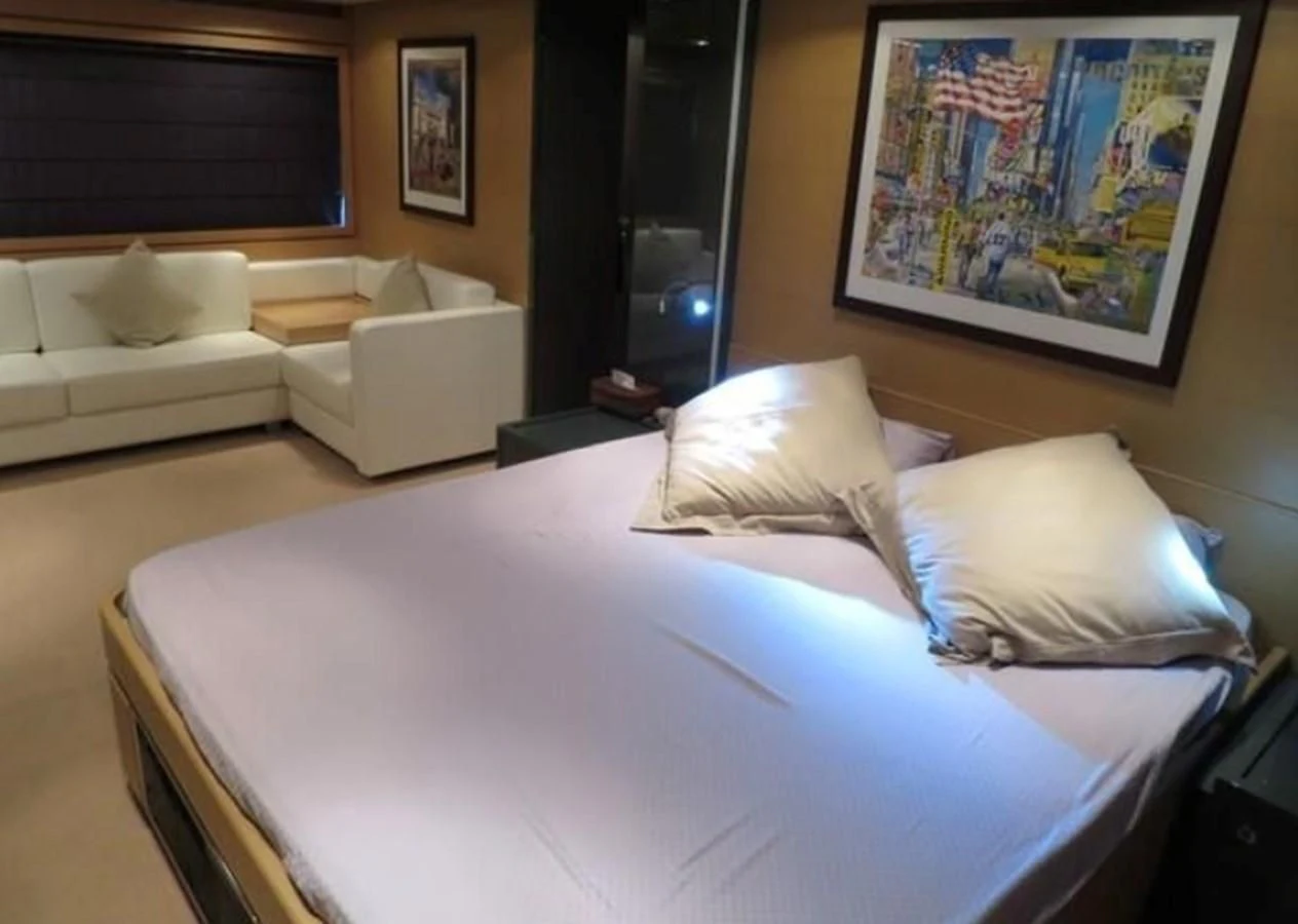 a bed with white sheets aboard RIVA 86 DOMINO Yacht for Sale