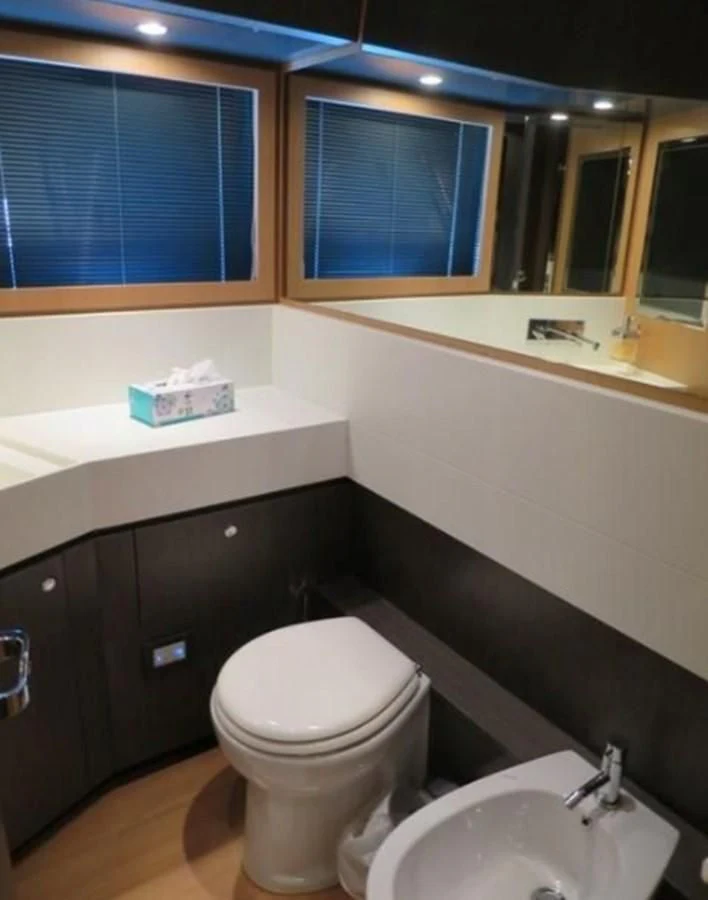 a bathroom with a toilet and sink aboard RIVA 86 DOMINO Yacht for Sale
