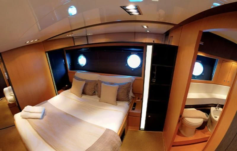 a room with a bed and a mirror aboard LET MY PEOPLE GO Yacht for Sale