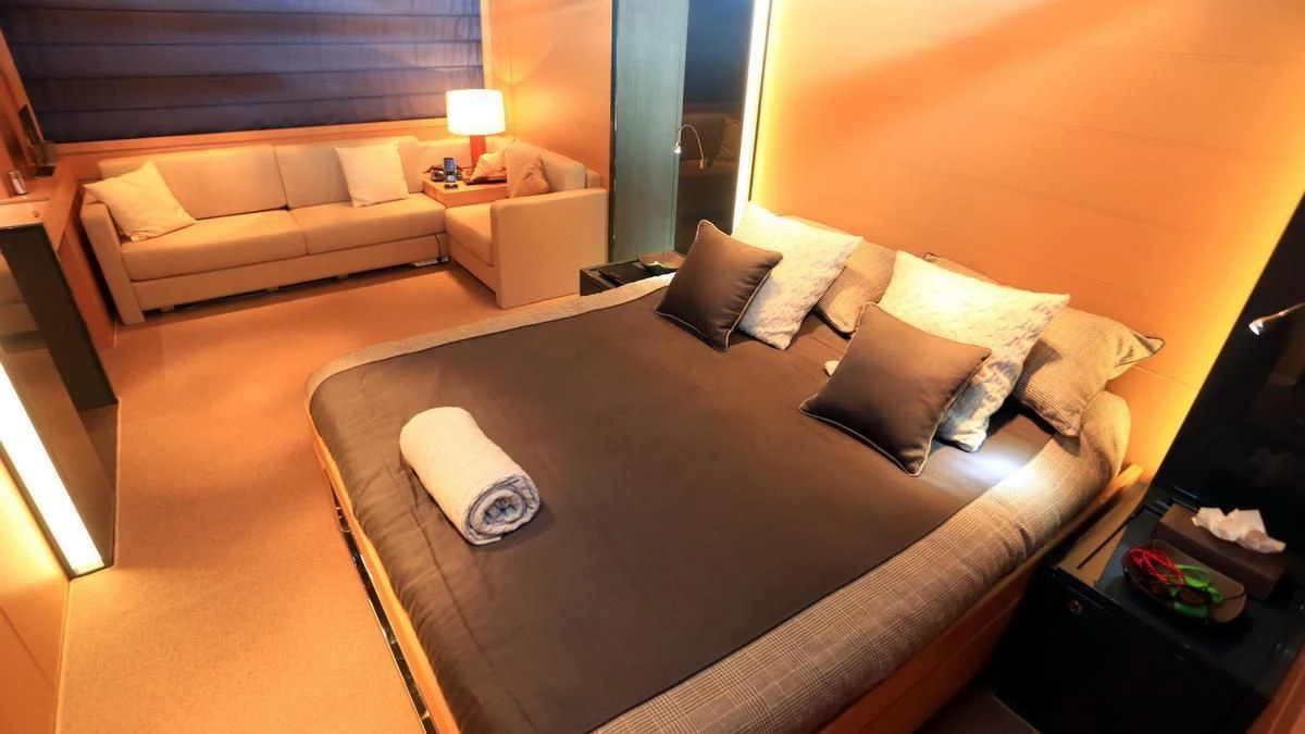 a hotel room with a bed and a couch aboard LET MY PEOPLE GO Yacht for Sale