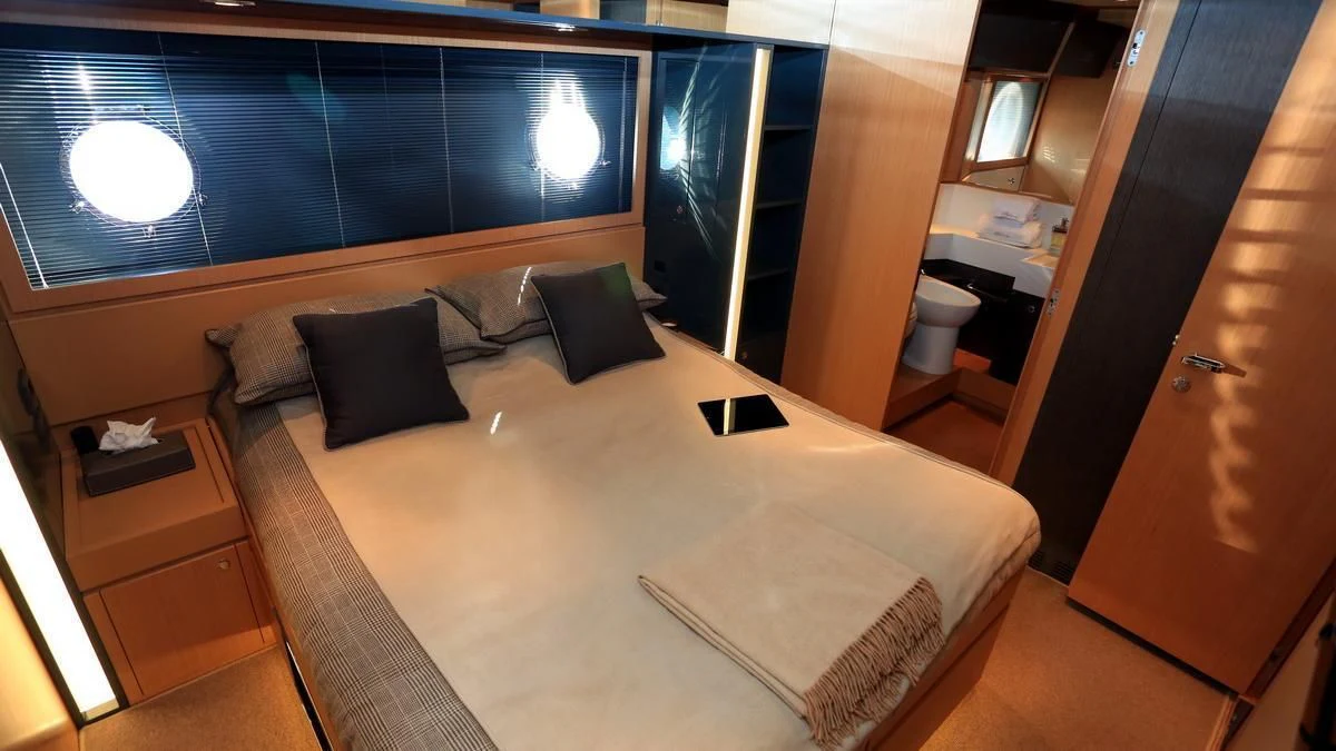 a room with a bed and a desk aboard LET MY PEOPLE GO Yacht for Sale