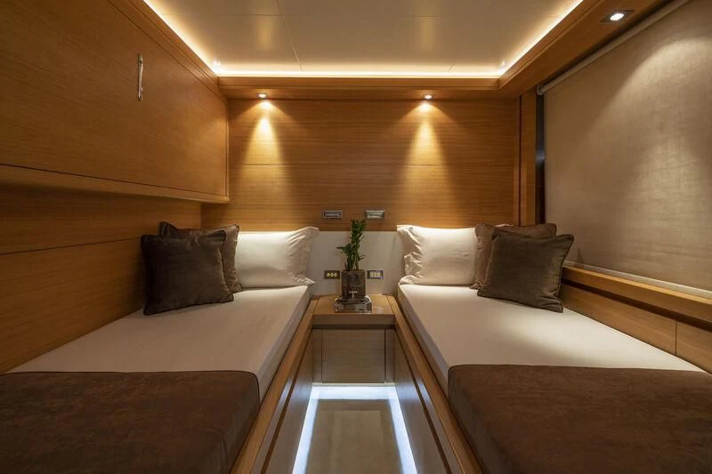 a room with a bed and a table aboard SANSARA Yacht for Sale