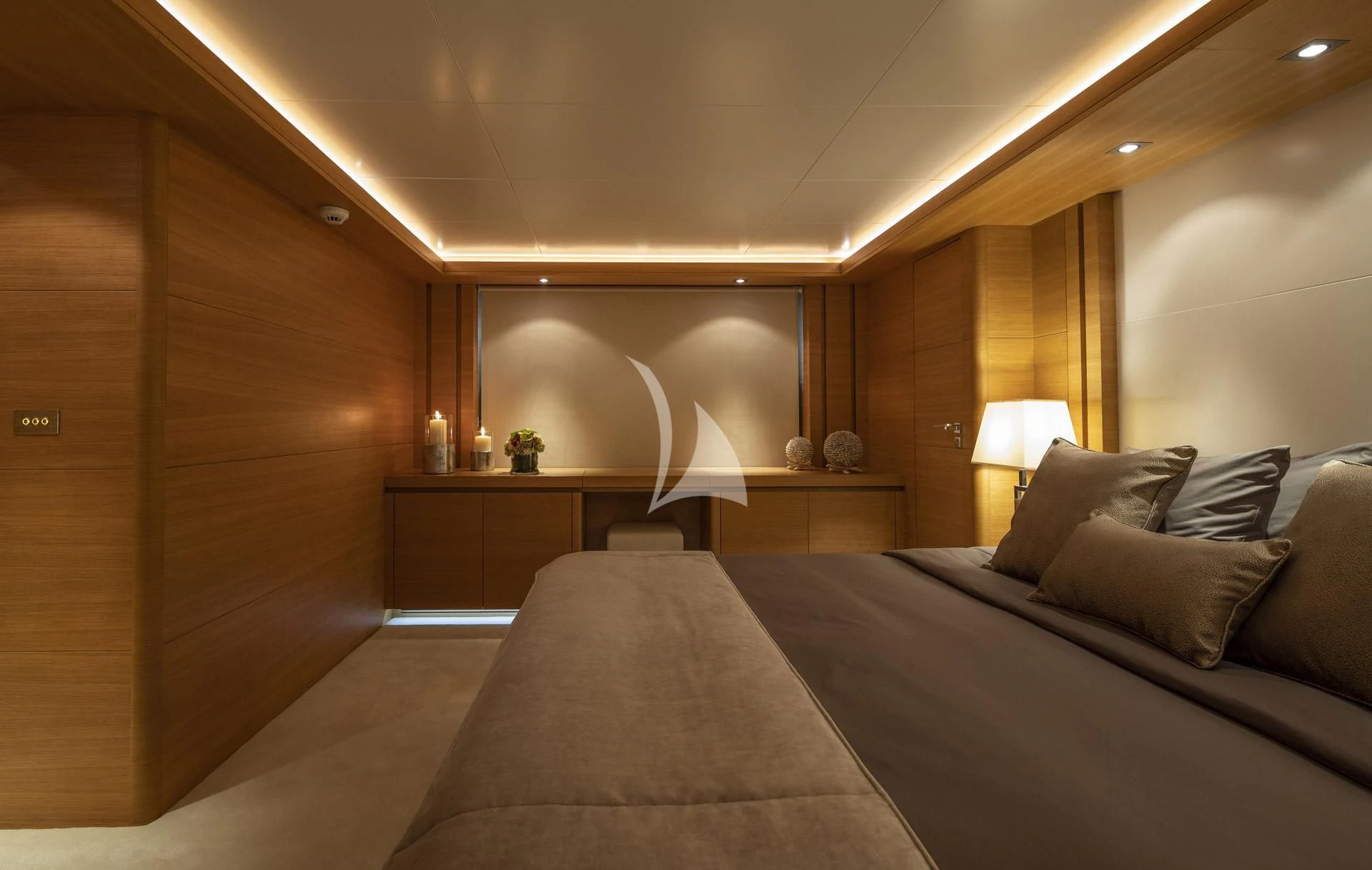 a bed with a lamp on it aboard SANSARA Yacht for Sale