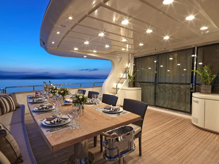 a large room with a table and chairs aboard SANSARA Yacht for Sale
