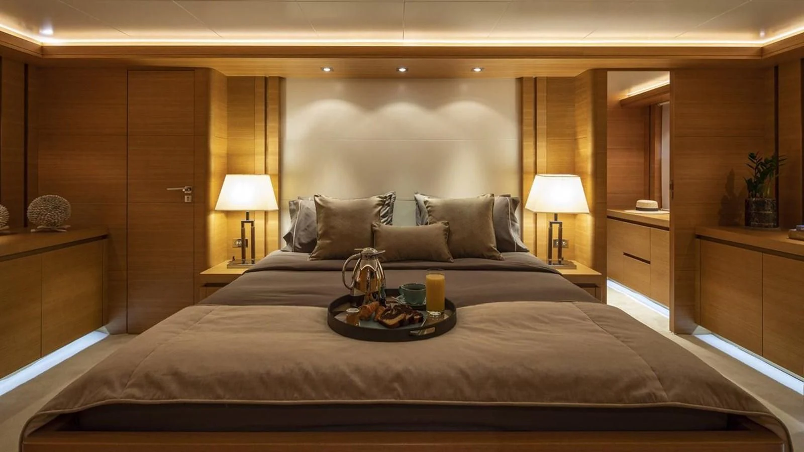 a bed with a tray of food on it aboard SANSARA Yacht for Sale