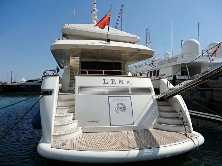 a white boat with a red flag on it aboard SANSARA Yacht for Sale