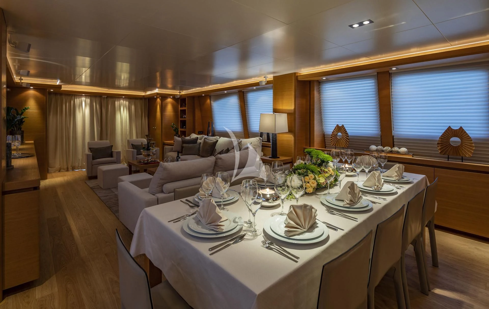 a large dining room with a large table set for dinner aboard SANSARA Yacht for Sale