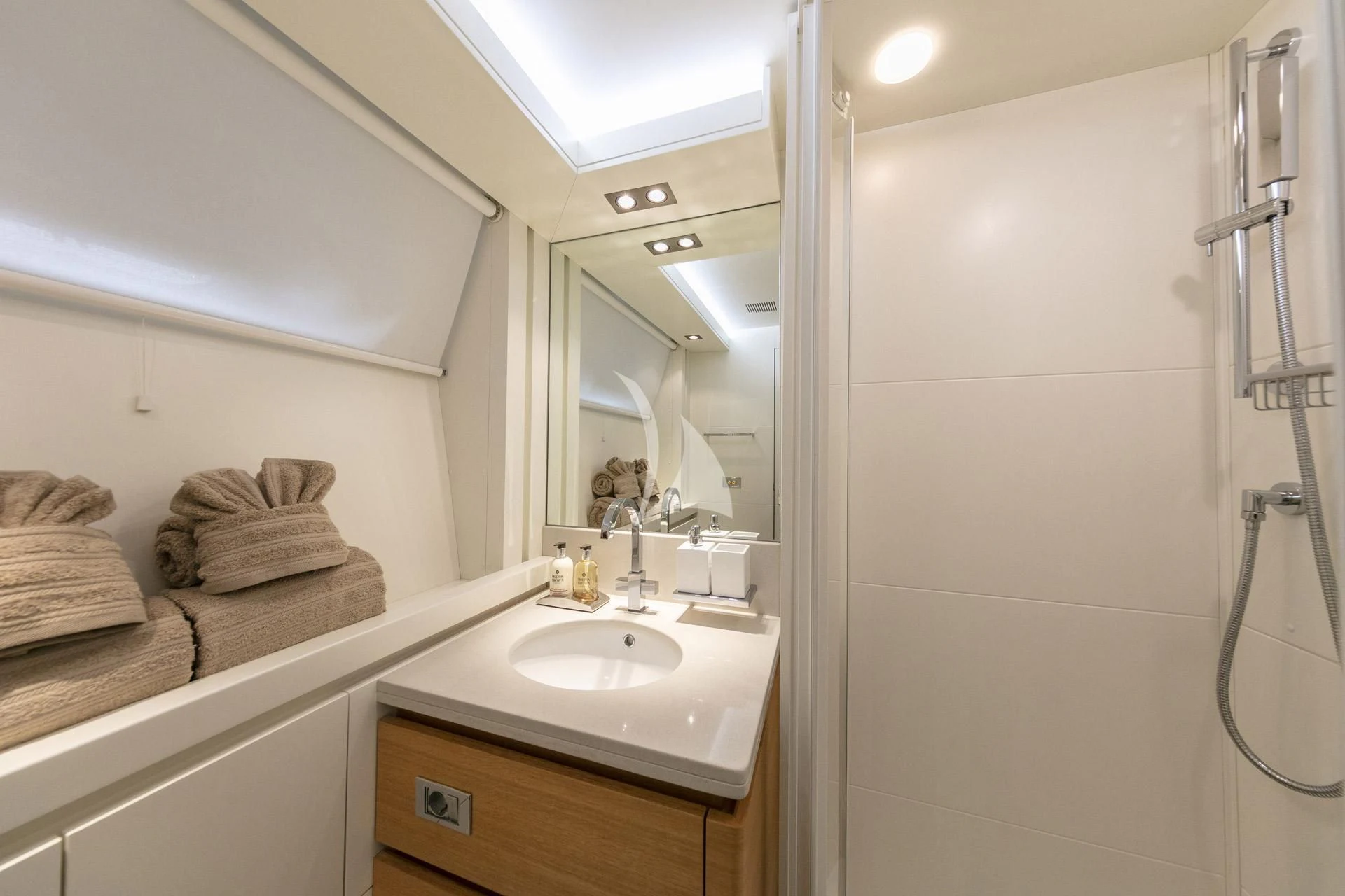 a bathroom with a mirror and a sink aboard SANSARA Yacht for Sale