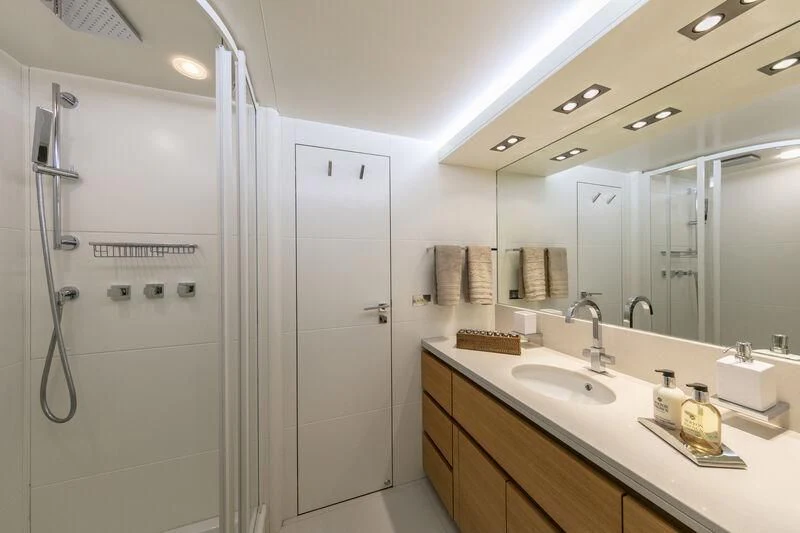a bathroom with a shower and sinks aboard SANSARA Yacht for Sale