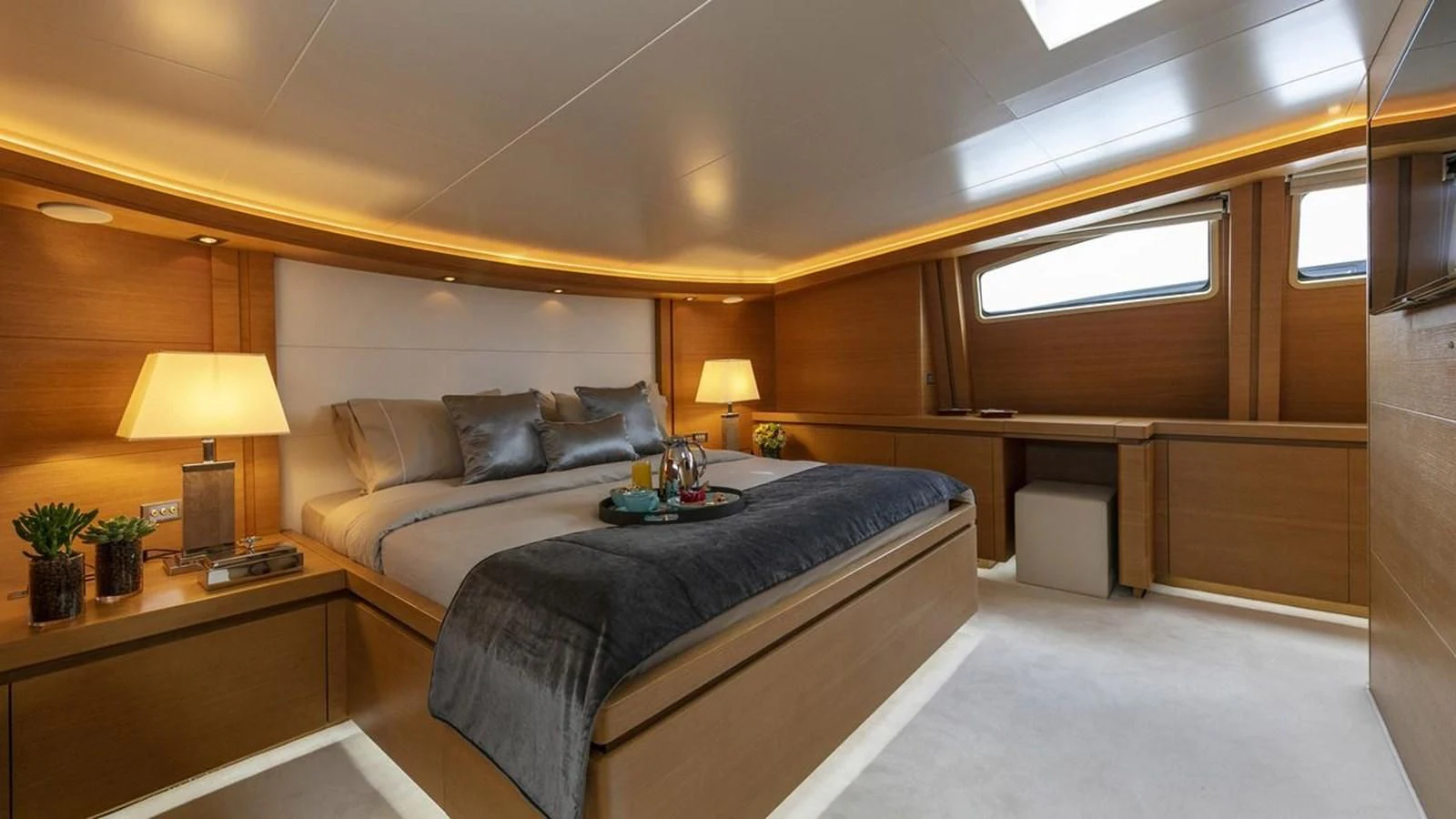 a bedroom with a bed and desk aboard SANSARA Yacht for Sale