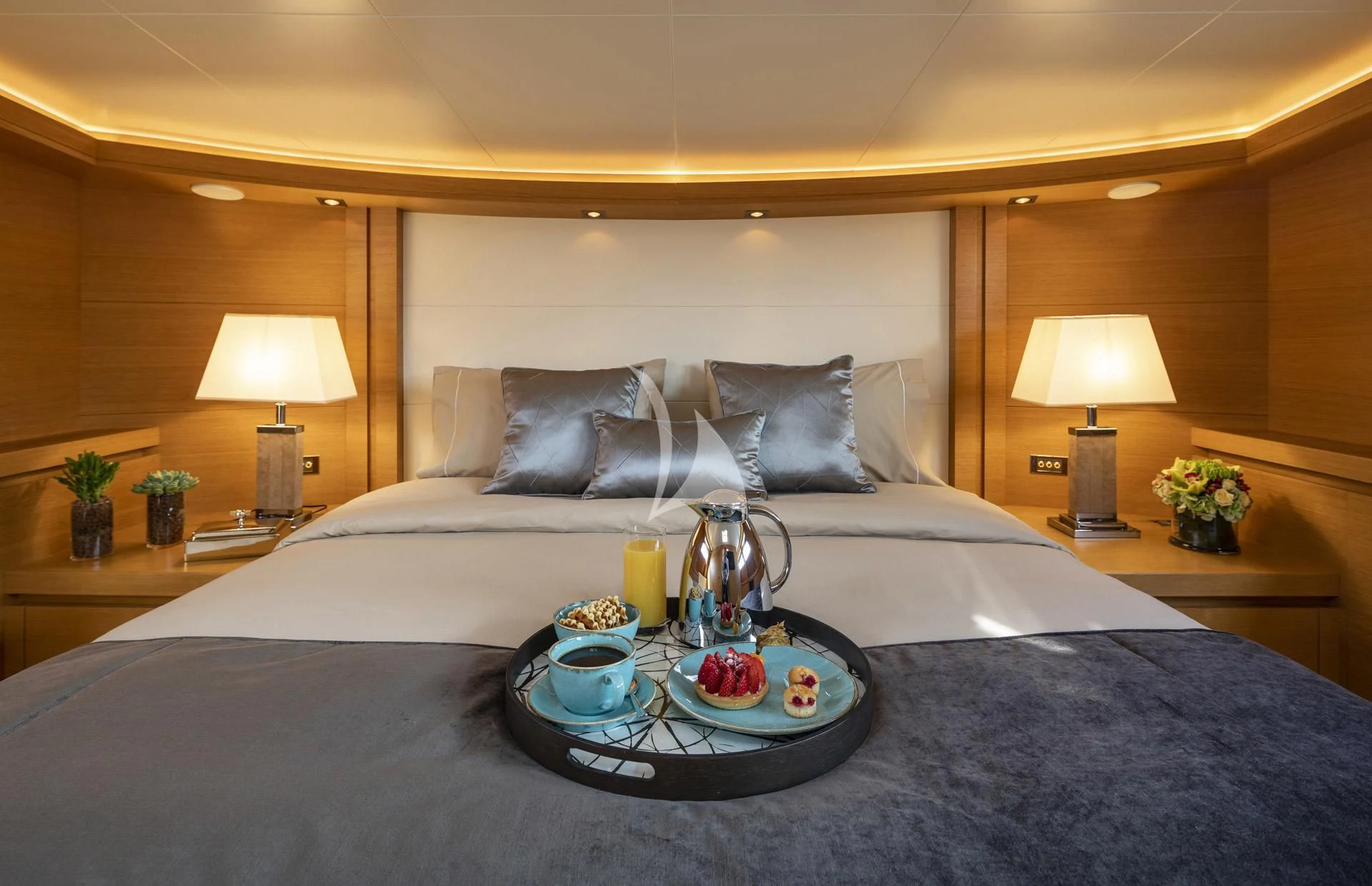 a bed with a tray of food on it aboard SANSARA Yacht for Sale