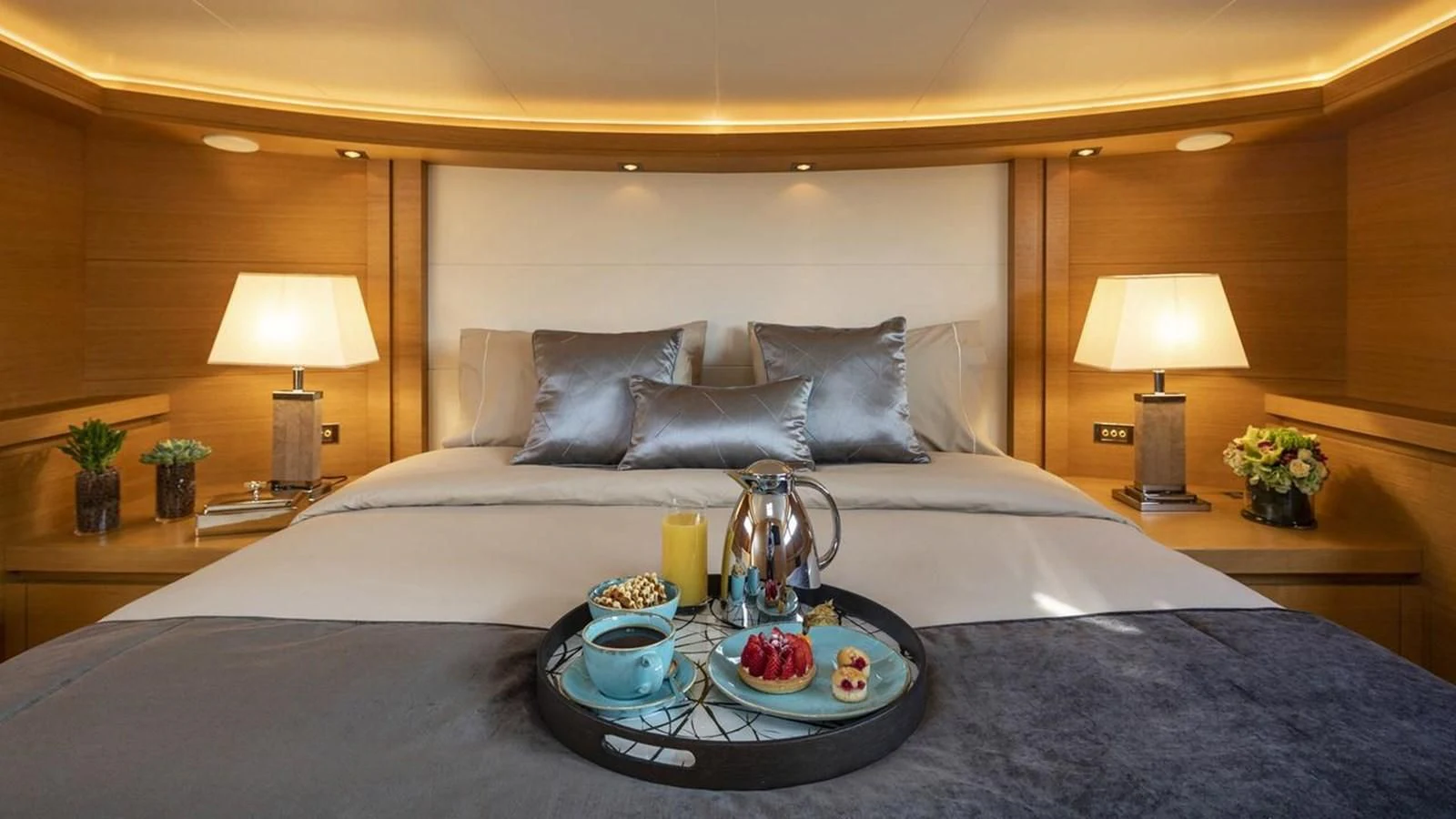 a bed with a tray of food aboard SANSARA Yacht for Sale